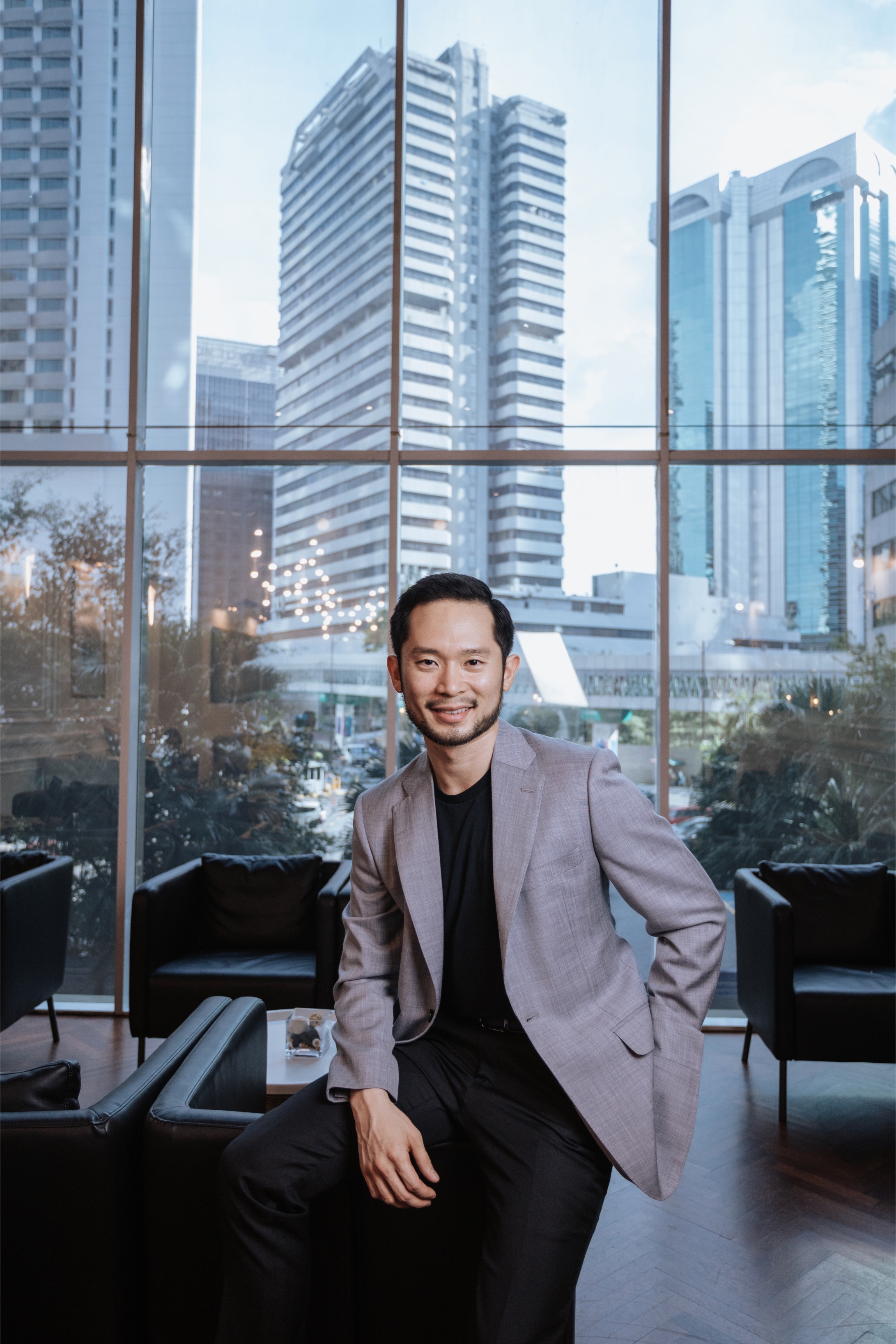 Chan Eu Boon, photographed in a lounge with a city skyline behind him, Kuala Lumpur.