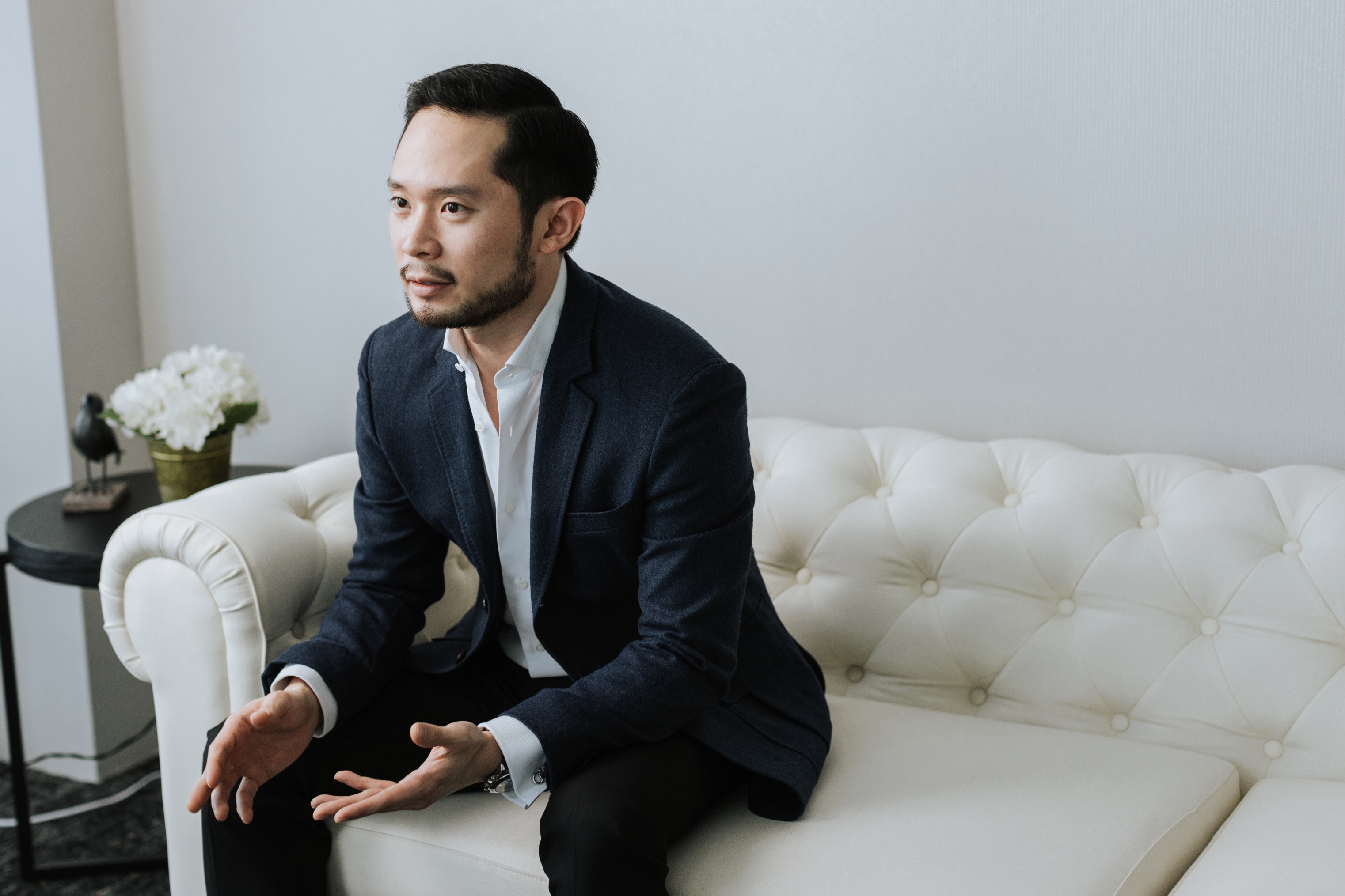 Chan Eu Boon seated and mid-conversation during an interview session.