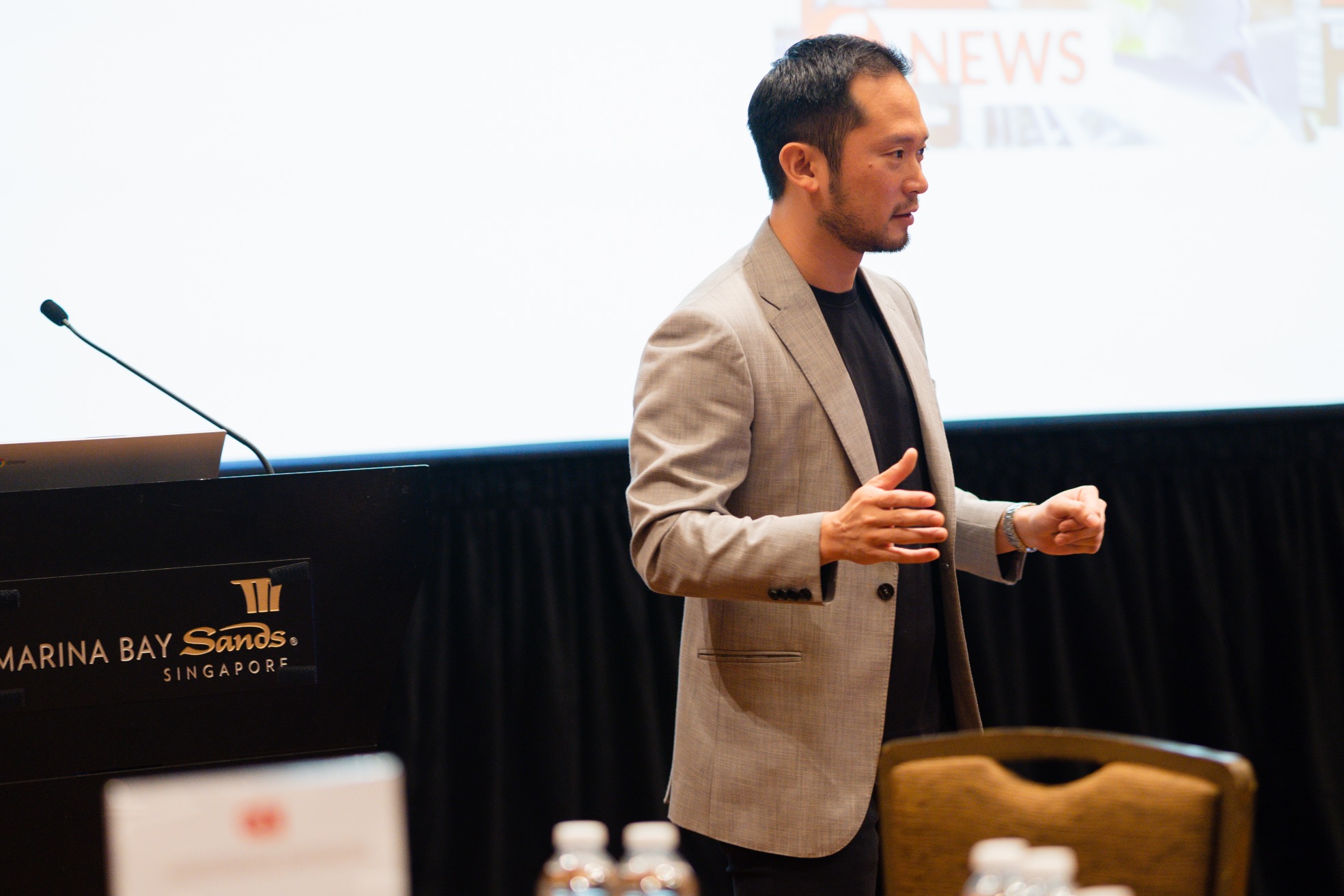 Chan Eu Boon speaking on stage at GDI 2023, Marina Bay Sands, Singapore.